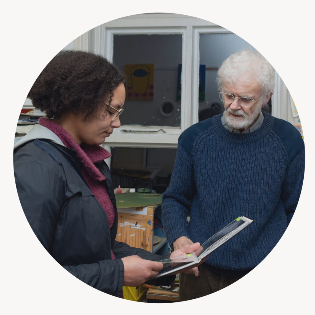 Two people discussing art in a book.